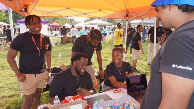 photo of students at a table during a on-campus event